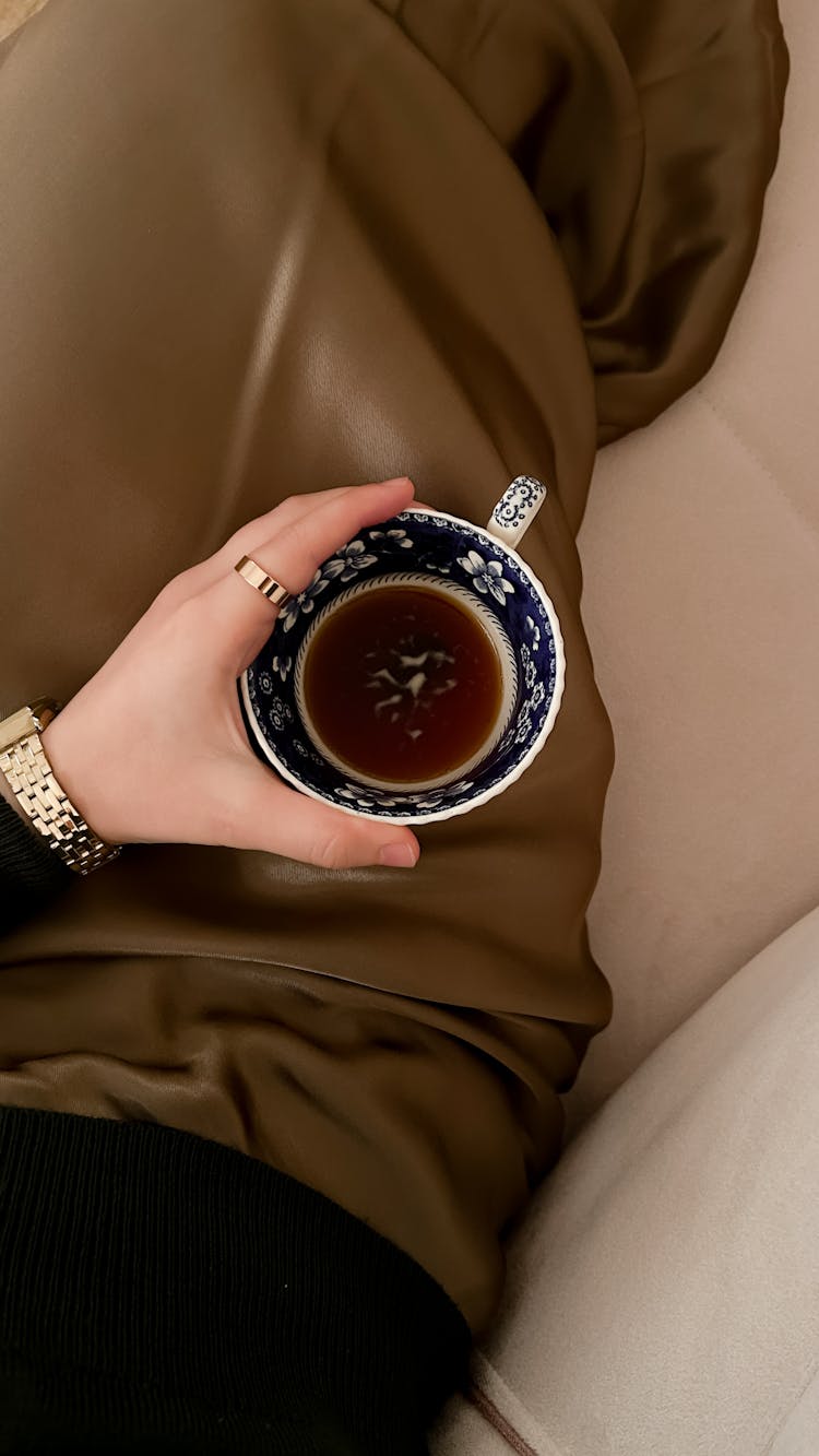 Woman Holding A Porcelain Cup With Tea