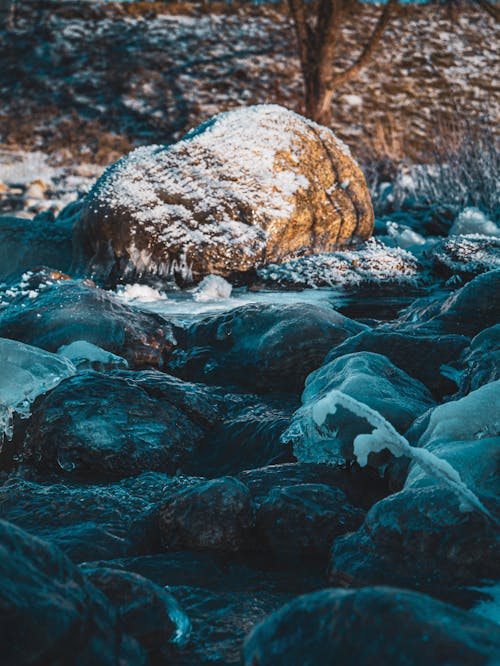 Close-up of Frozen Water on the Rocks in a Stream 