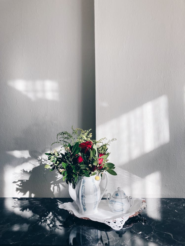 Sunlit Porcelain Vase With Flowers Standing On A Table