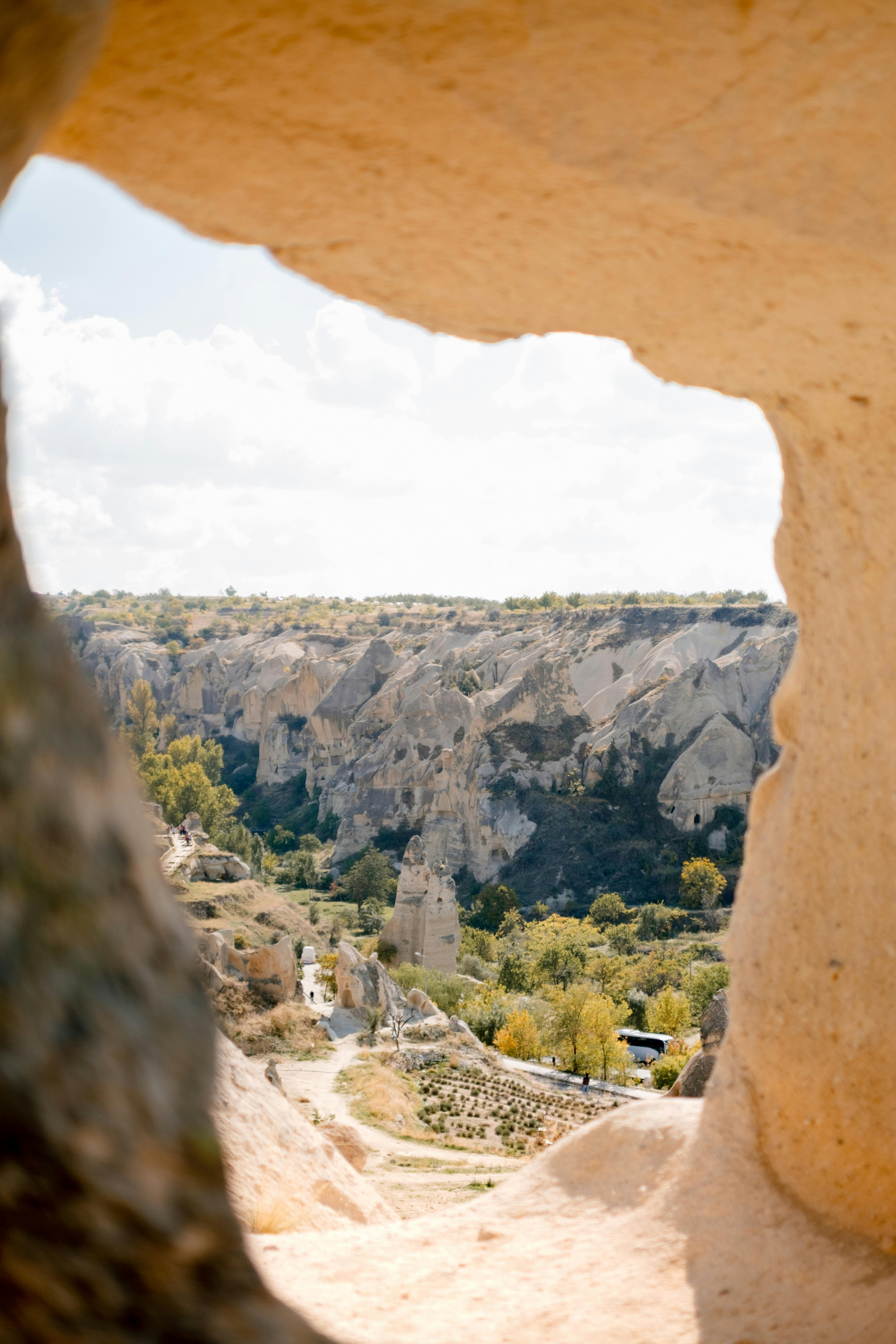 Breathtaking landscape of Cappadocia seen through a rock formation, revealing unique eroded structures.
