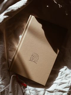 Kraft-bound quarterly journal, photo by Book Hut on Pexels