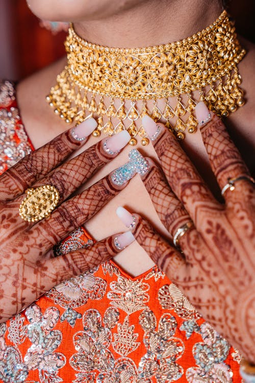 Close-up of Woman Wearing Jewelry and Henna Tattoos on Her Hands 