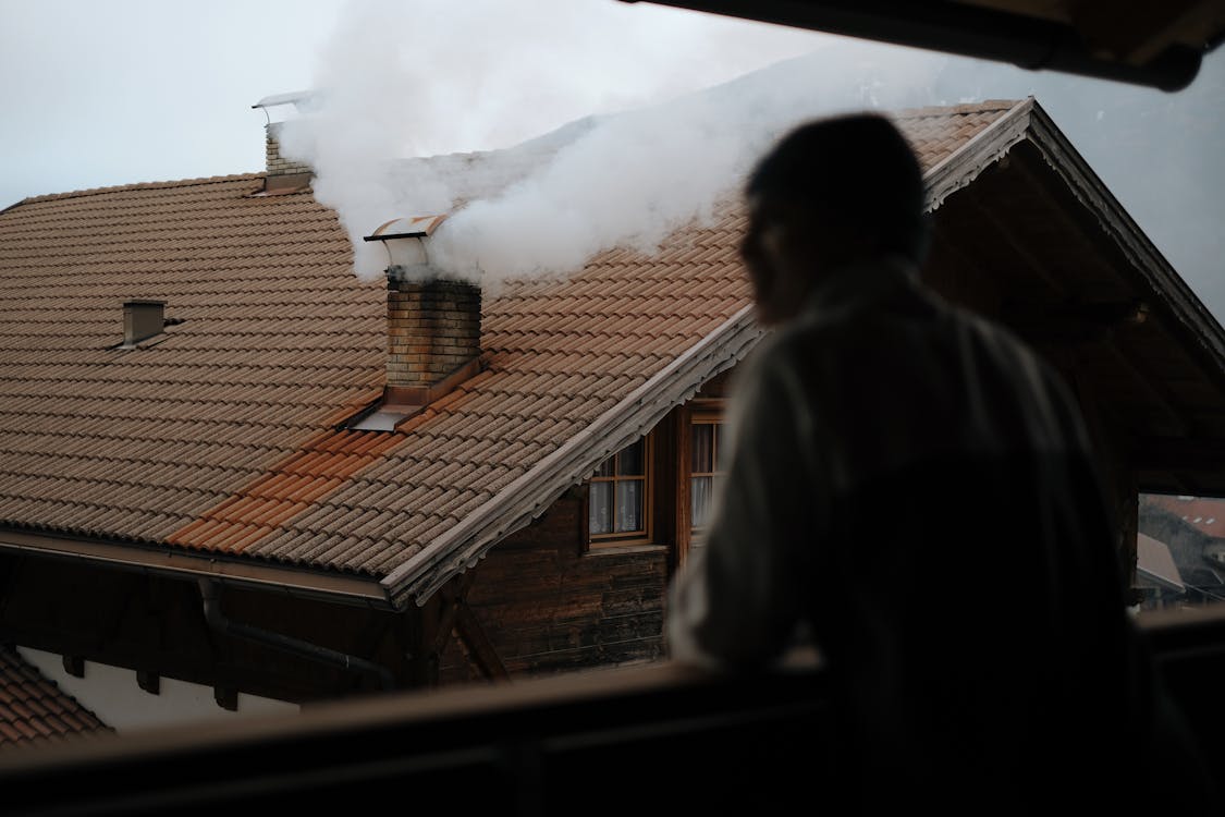 Chimney Smoke behind Standing Man · Free Stock Photo