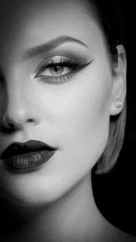 Elegant black and white close-up portrait capturing glamour and beauty.
