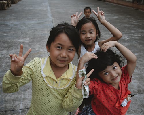 Smiling Girls Posing with V Signs