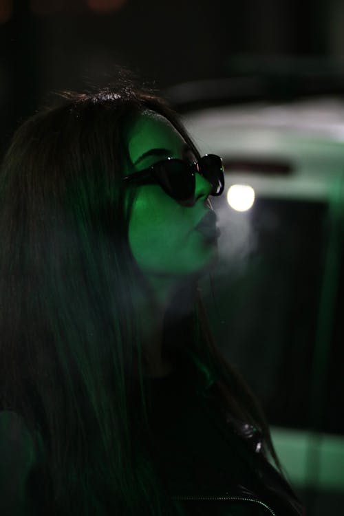 Portrait of Woman in Sunglasses at Night