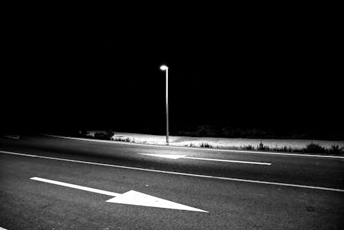 Empty Street in City Illuminated with a Lantern at Night 