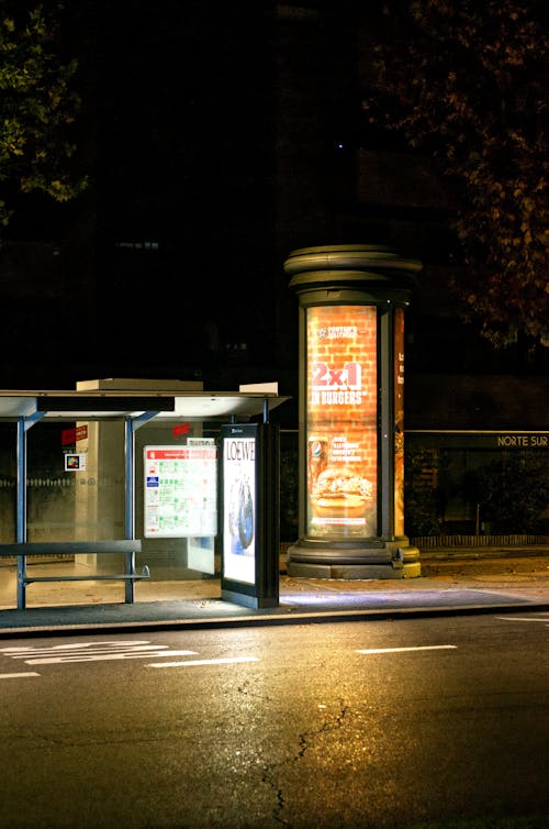 Illuminated Bus Stop on City at Night 