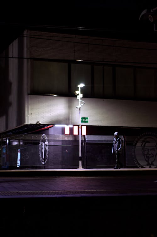 A Lantern Illuminating the Sidewalk at Night 
