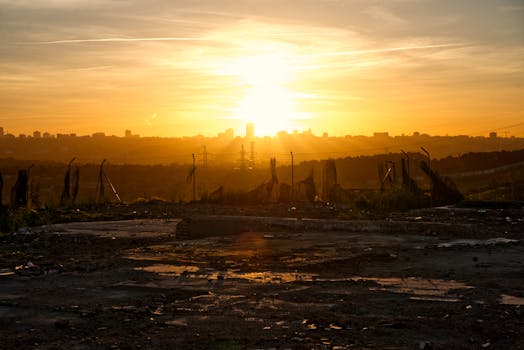 Dramatic sunrise illuminating a city skyline silhouette, ideal for urban landscape themes.