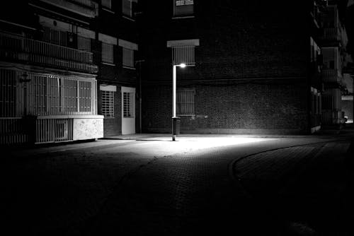 A Lantern Illuminating the Street in City at Night