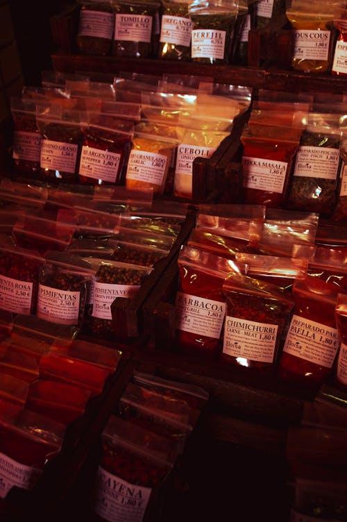 Shelves with Variety of Spices Packed in Bags 