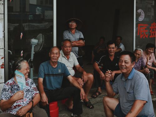Free Elderly friends enjoying a relaxing day outside, smiling and talking. Stock Photo