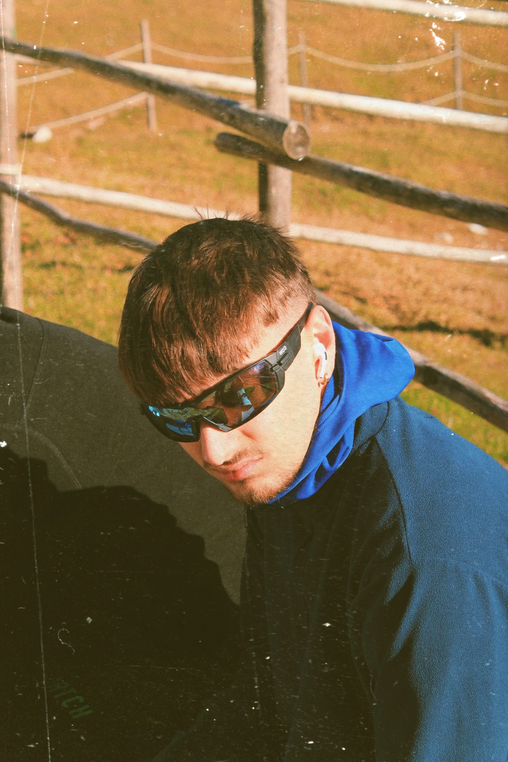 A modern young man in sunglasses enjoying a sunny day outdoors.
