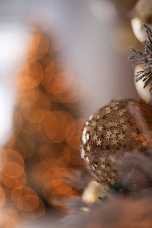 Close-up of a Golden Christmas Tree Bauble Decorated with Stars