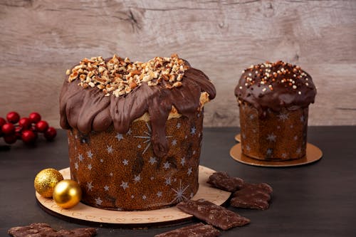 Christmas Cakes Covered in Chocolate and Topped with Crushed Walnuts and Sprinkles