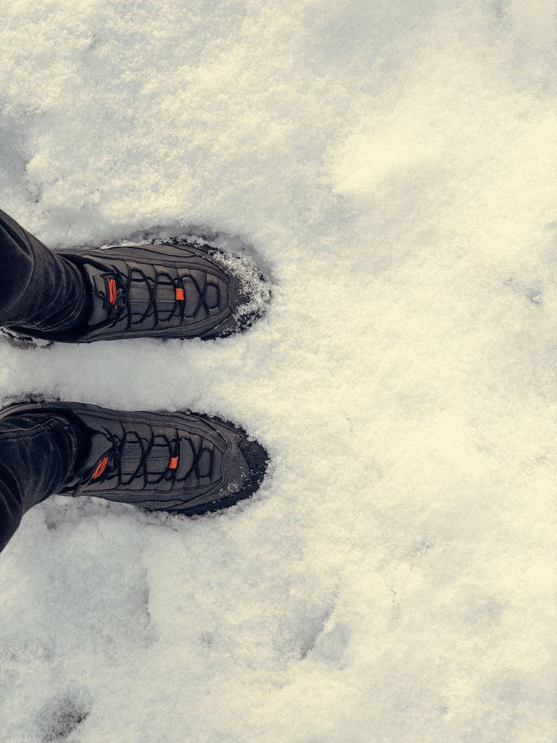 Shoes of person standing in snow
