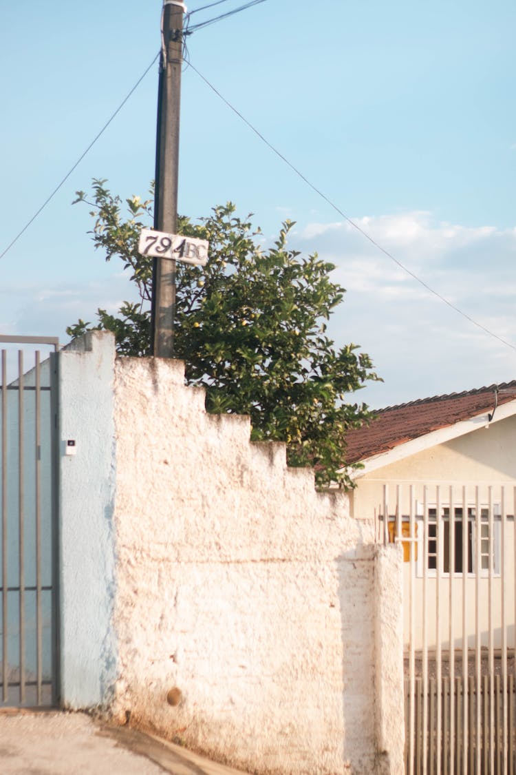 Pole With Sign By Fence