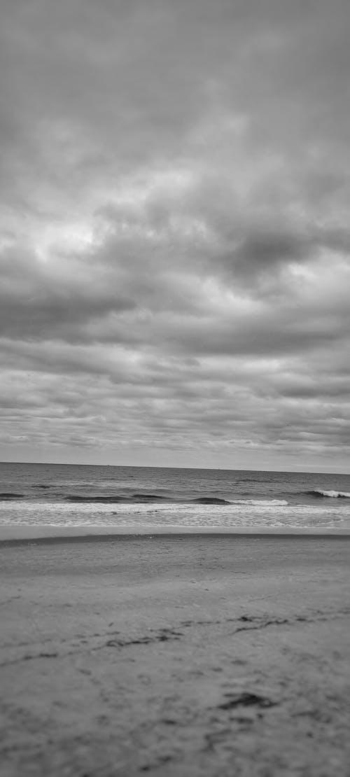 Foto profissional grátis de areia da praia, costa do oceano, mar aberto