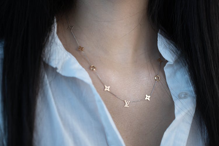 Close Up Of Woman In White Shirt And With Golden Necklace