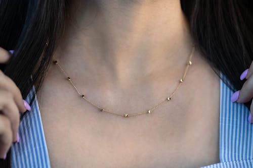 Close up of Golden Necklace on Woman Skin