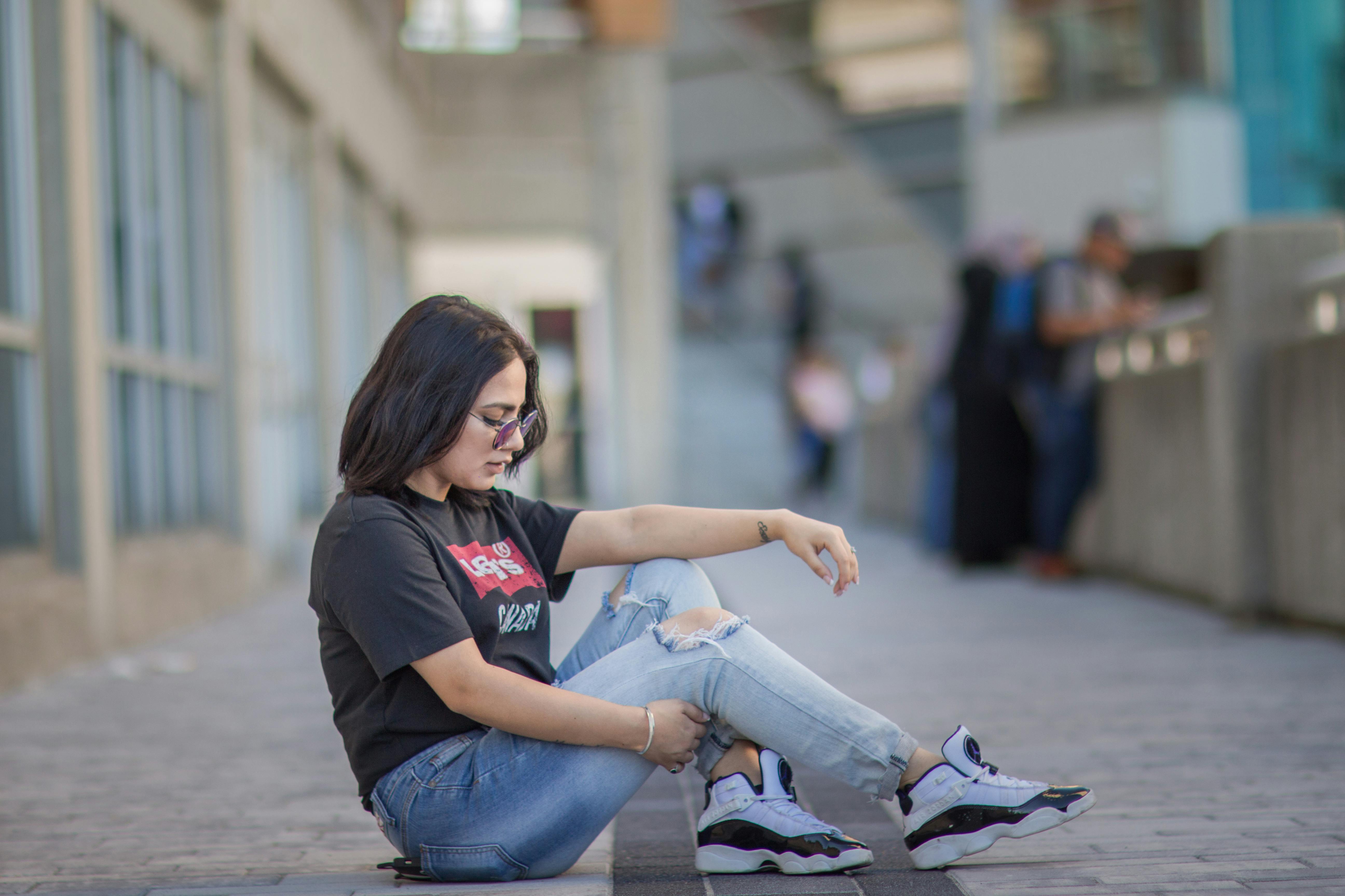 a woman sitting on the ground with her feet up