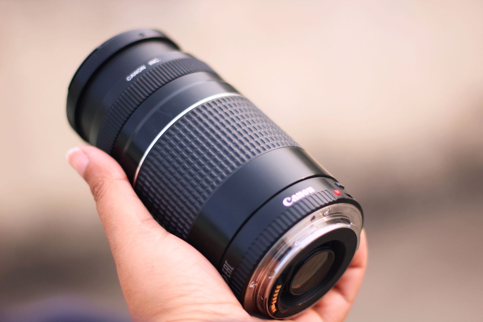 Photo of Hand Holding up a Black Canon Dslr Camera · Free Stock Photo
