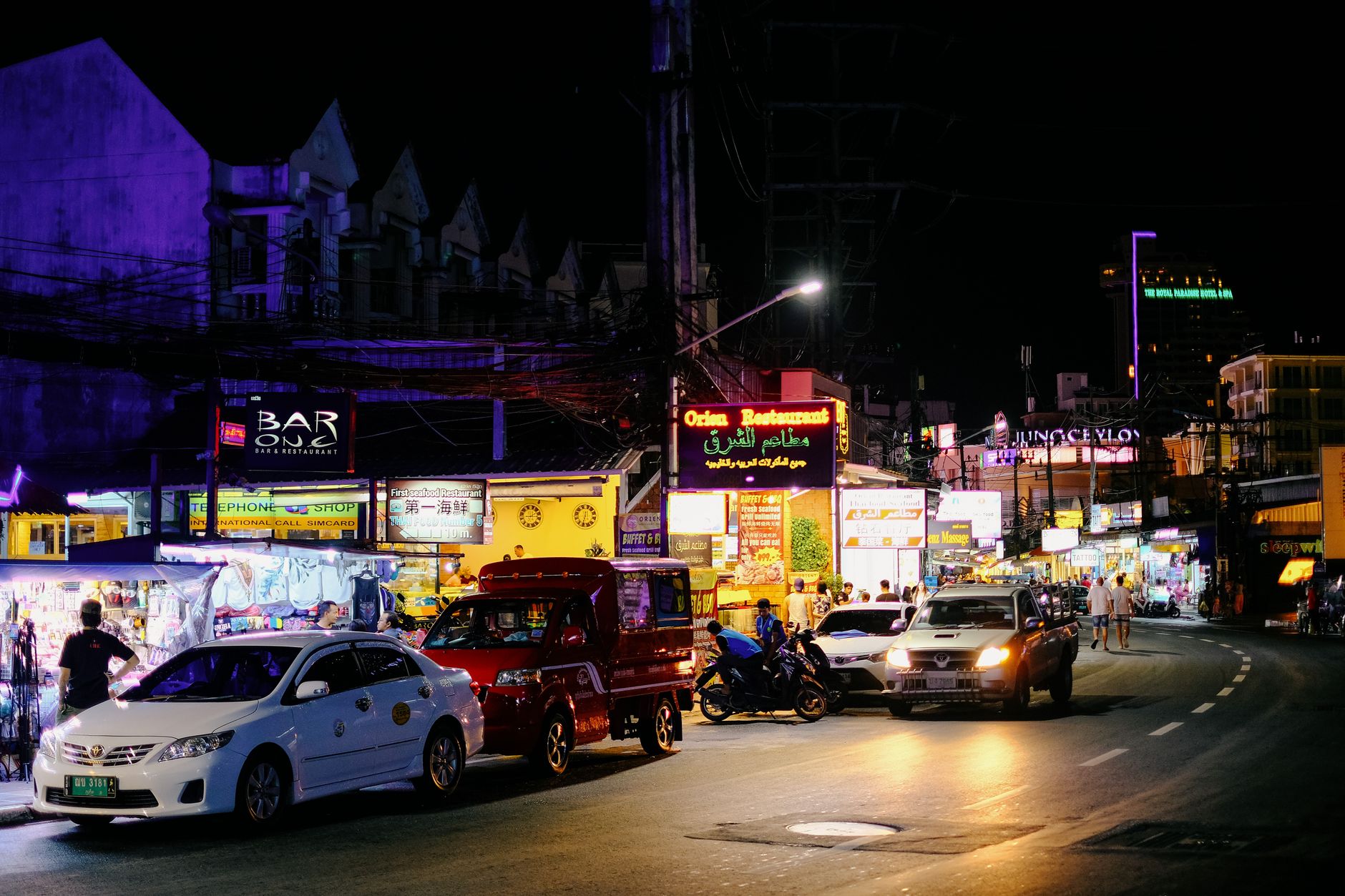 Neon signs and street food carts along Khao San Road at night