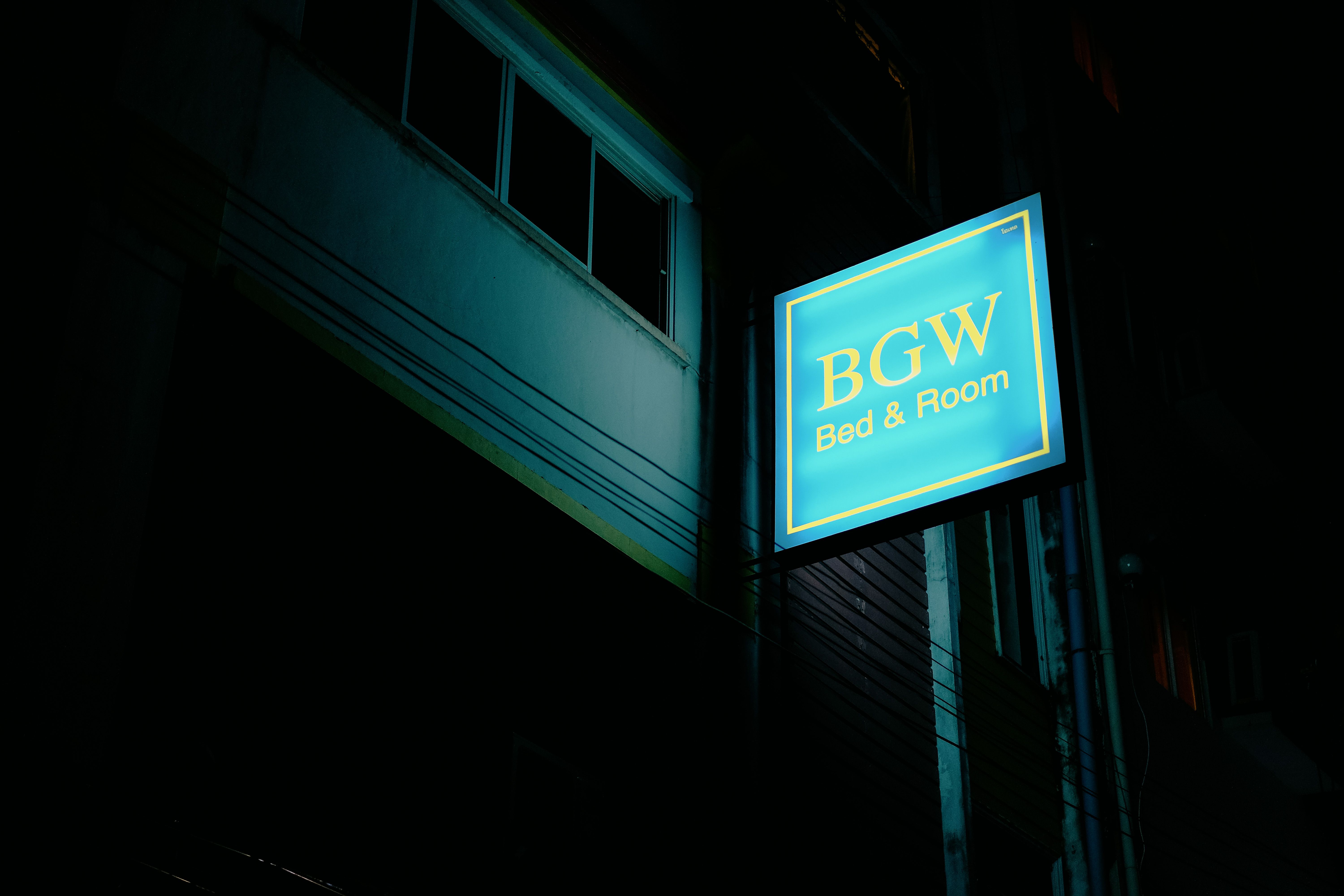 A softly lit hospital building signage at night.