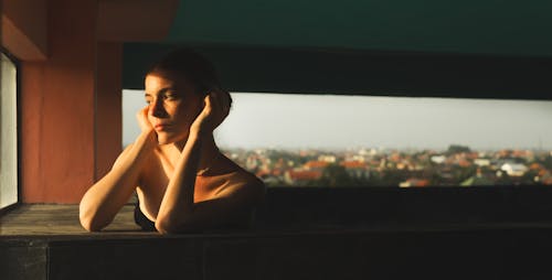 Woman Sitting by the Window in Sunlight 