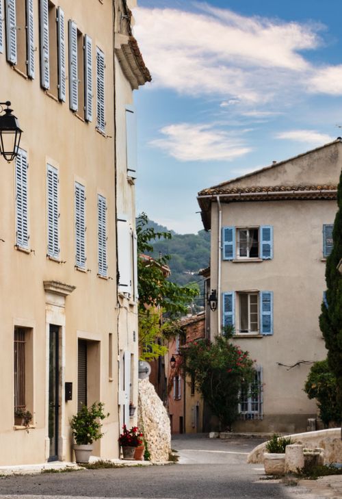 Free Scenic view of a picturesque village street with European architecture, shutters and cobblestone. Stock Photo