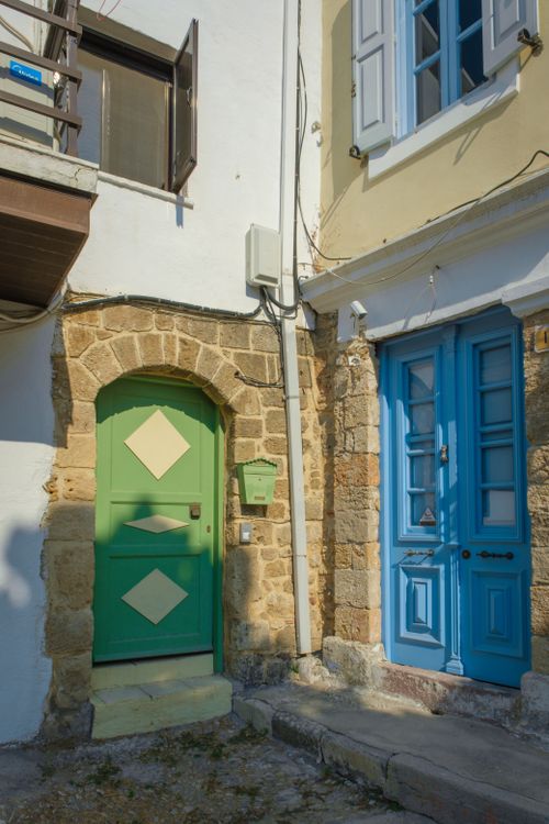 Free Colorful Mediterranean doors with historical stone walls under bright daylight. Stock Photo
