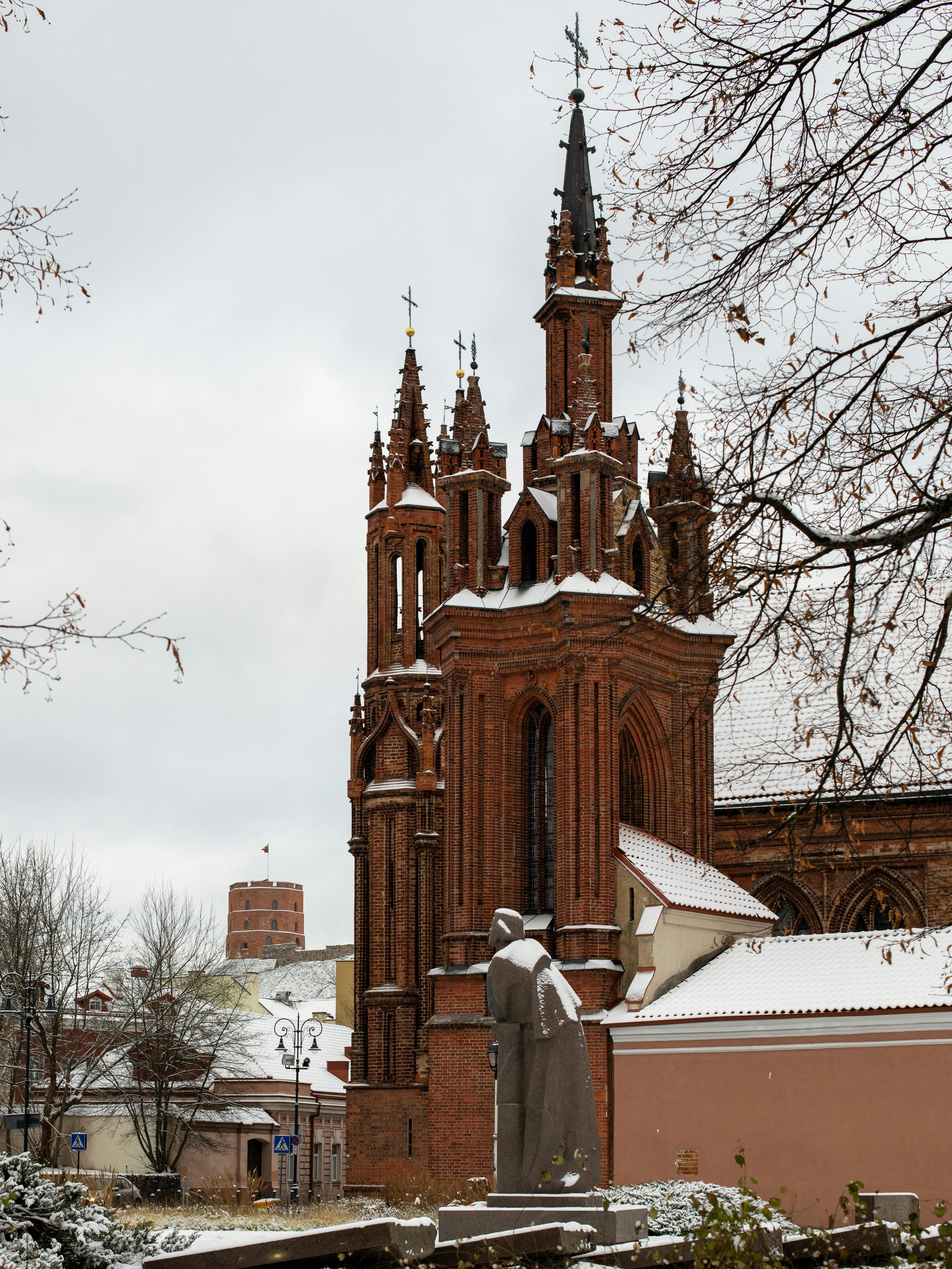 Gothic St. Anne's Church covered in snow, showcasing architectural beauty in Vilnius, Lithuania.