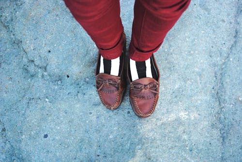 Crop stylish man in old fashioned footwear and striped socks