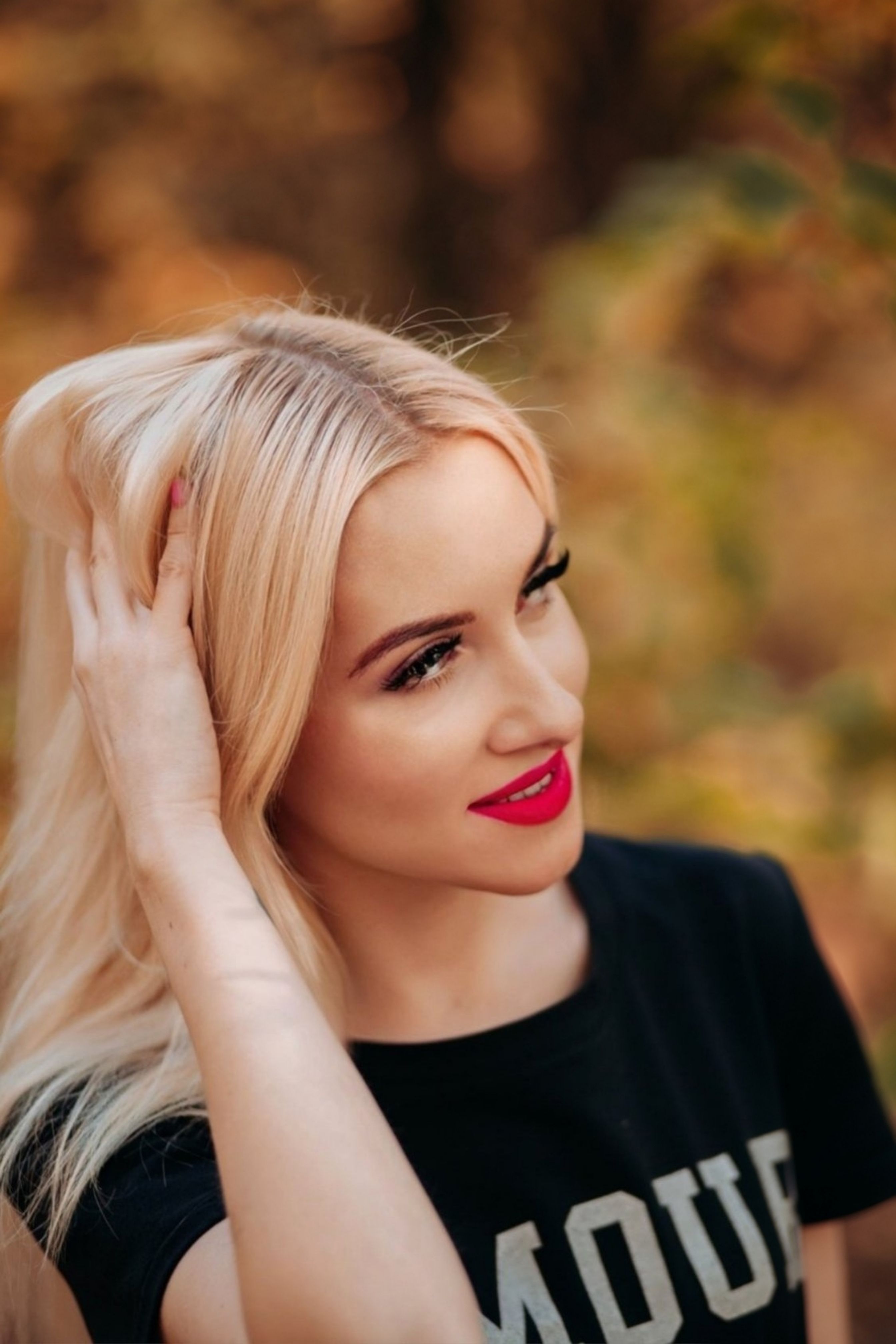 Blonde Woman Posing Among Shrubs · Free Stock Photo