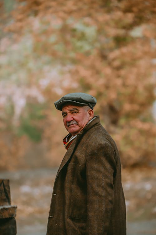 Elegant Elderly Man with Mustache Standing Outside 