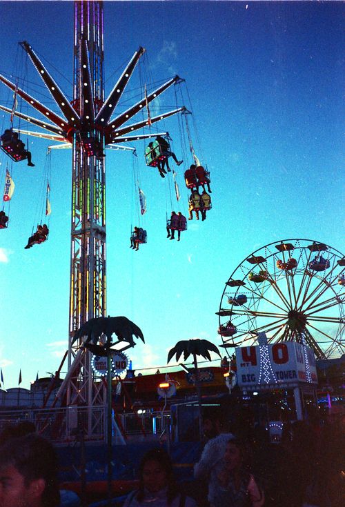Free Experience the thrill of Legnano's amusement park rides against a stunning evening sky. Stock Photo