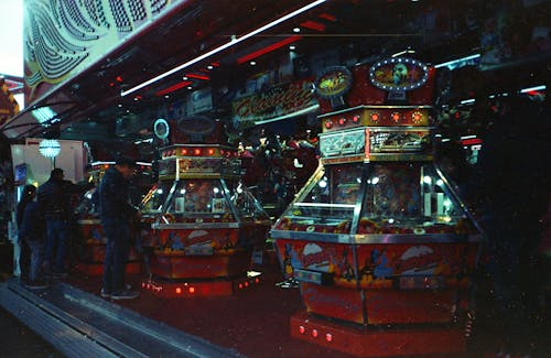 People around Arcade Machines at Amusement Park