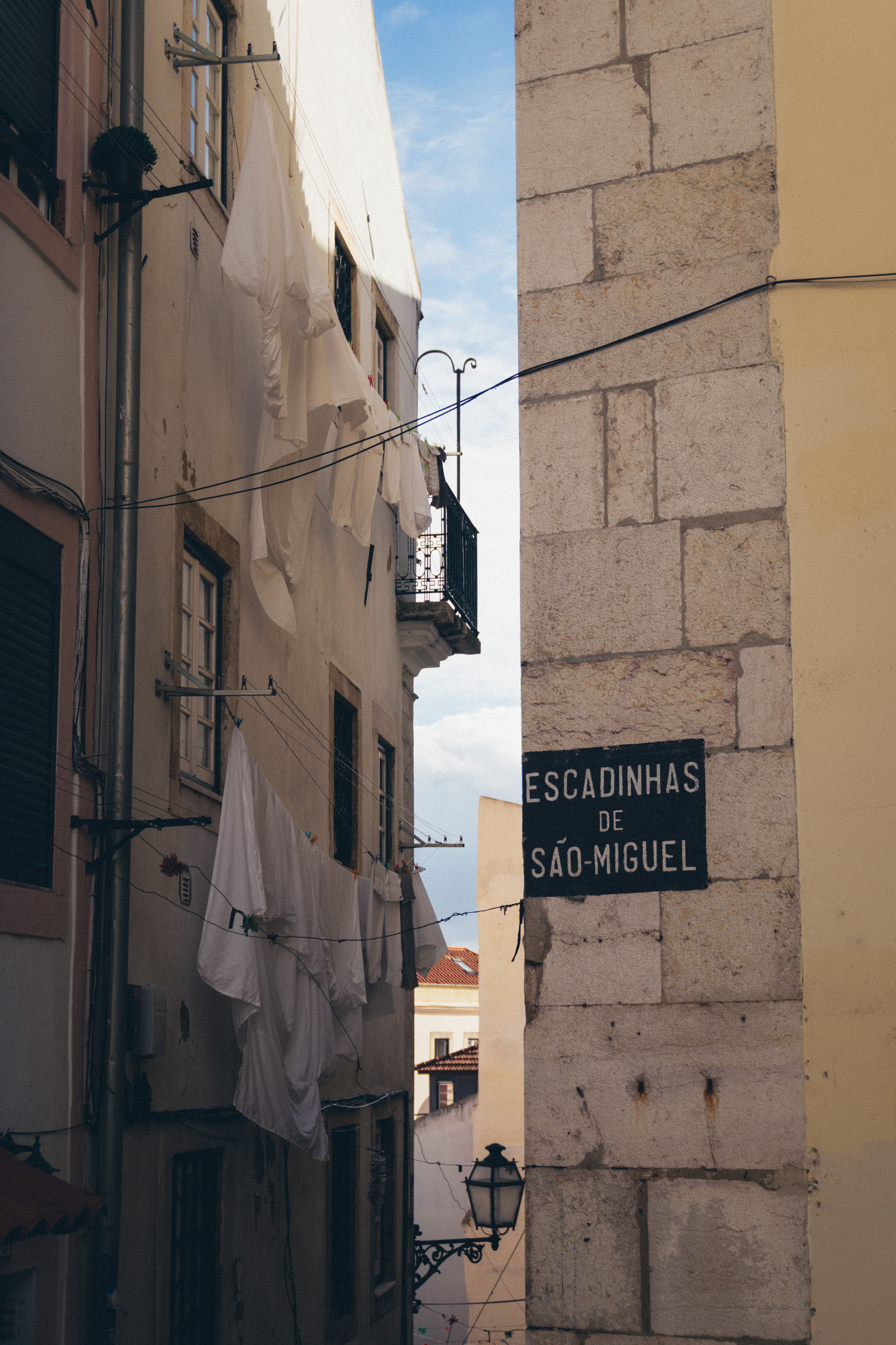 A charming alley in Lisbon with a historic vibe and laundry on clotheslines.