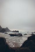 Misty seashore boulders — photo by Taras Chuiko on Pexels