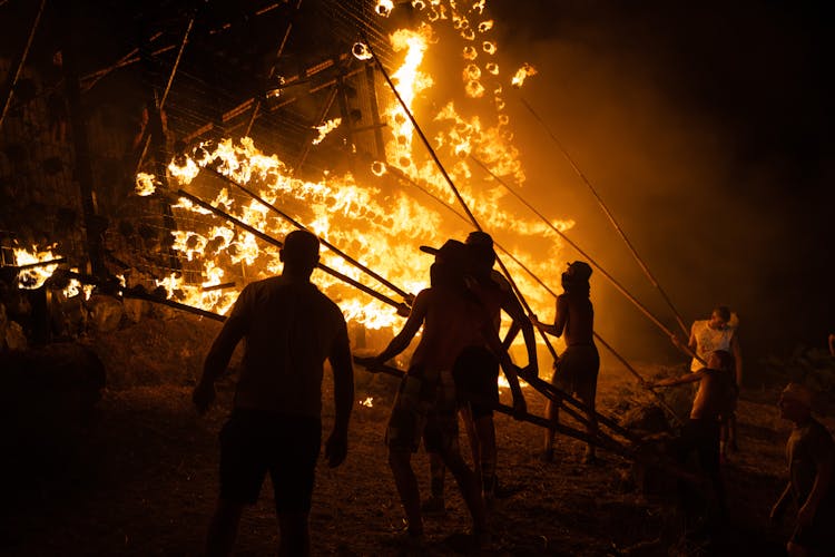 Silhouette Of People In Front Of A Fire