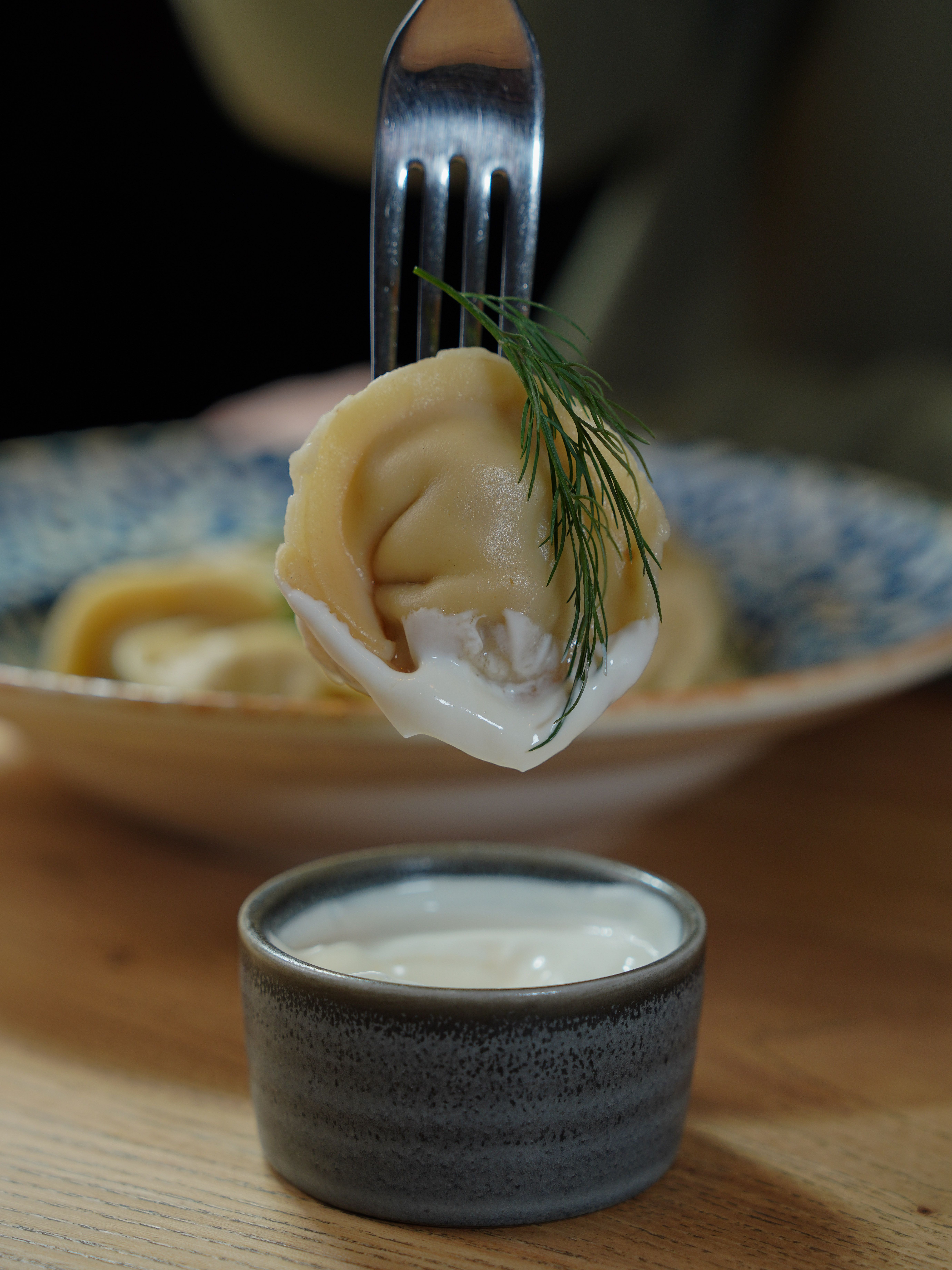 Fork piercing cooked dumpling to test doneness and texture`
