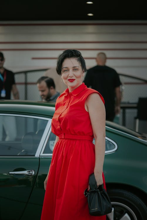 Woman in Red Dress Standing near Car