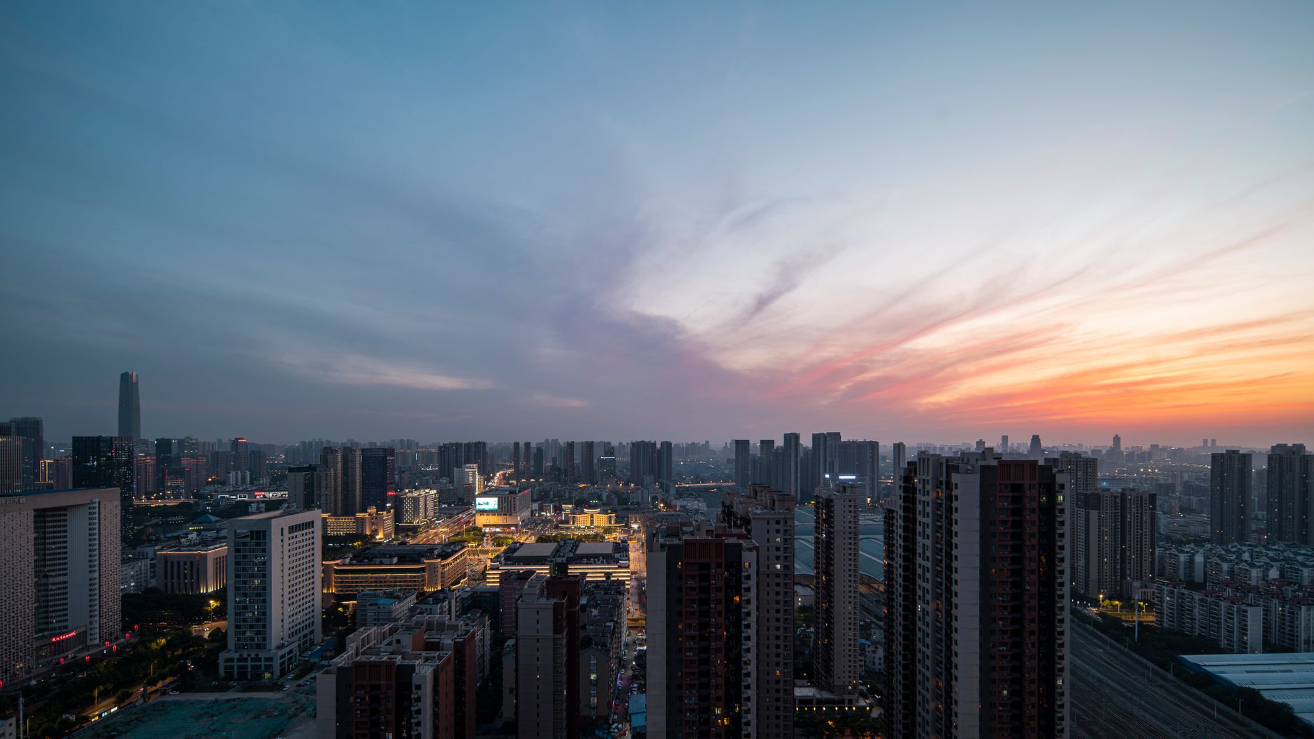 A stunning urban skyline at sunset showcasing high-rise buildings and vibrant colors.