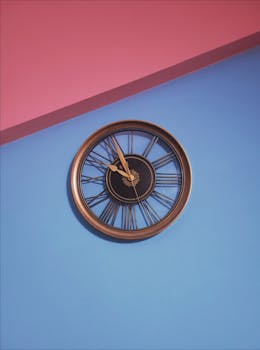 Stylish vintage clock on a colorful blue and pink wall adds artistic flair.