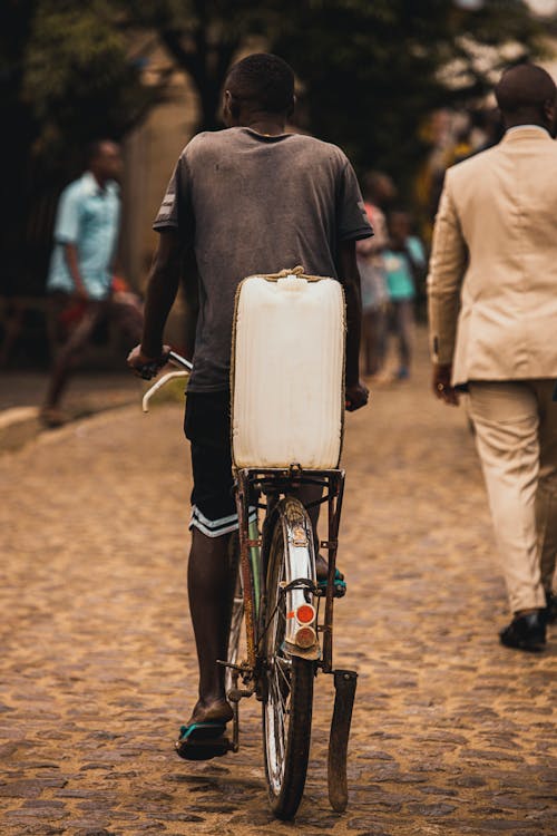 Man with Plastic Container on Bike