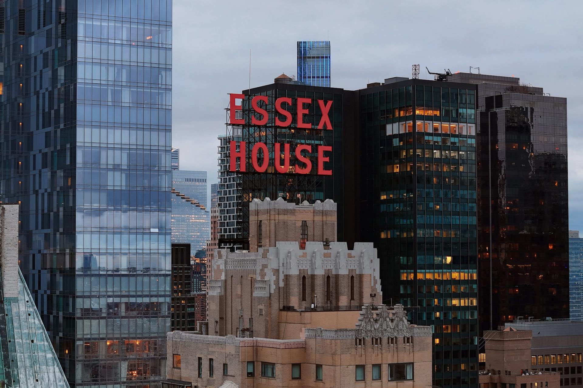An urban skyline view of buildings in New York City with prominent Essex House sign.