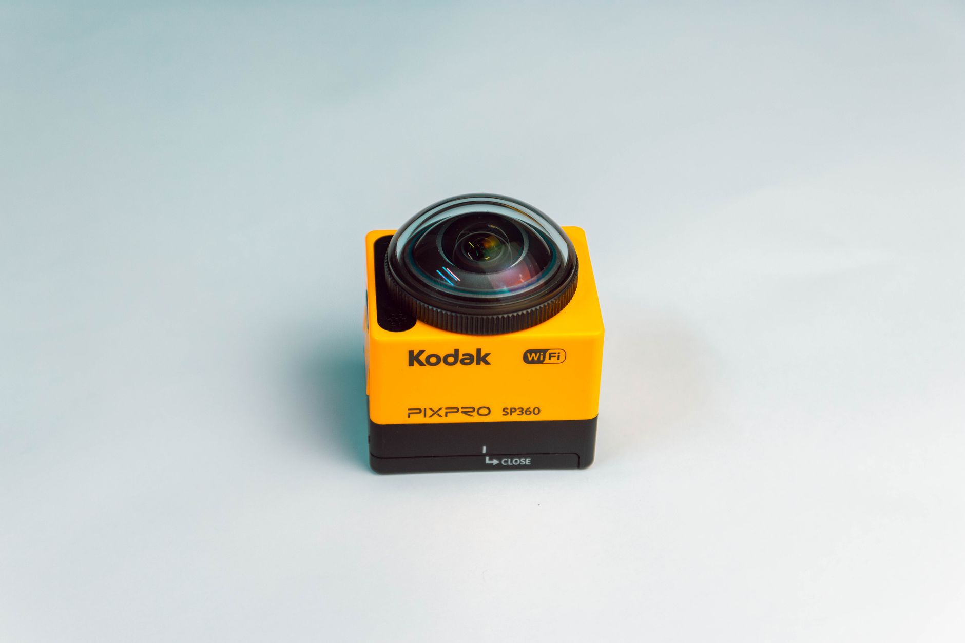 Compact yellow Kodak PIXPRO SP360 camera with fisheye lens against a gray background.