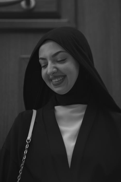 Black and White Photo of a Young Woman in a Hijab Smiling 
