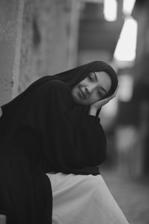 Free Elegant black and white portrait of a woman in a headscarf, captured outdoors. Stock Photo